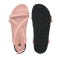 Pink sandal with criss-cross straps and black sole on a white background